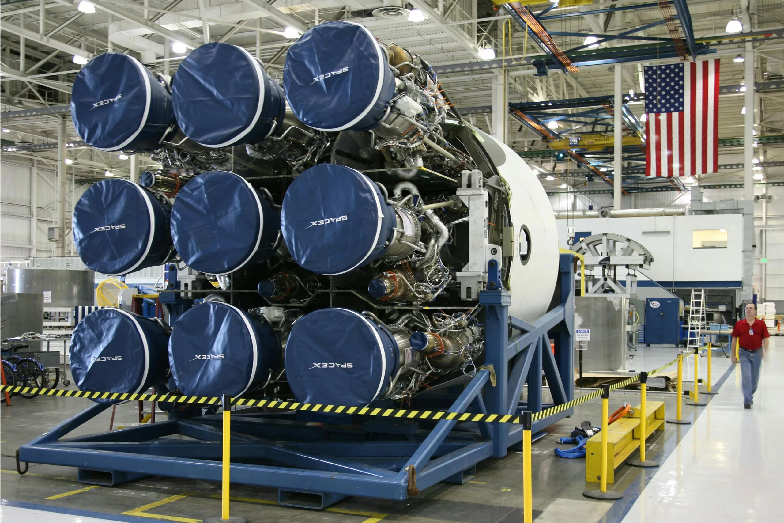 Aerospace manufacturing facility and rocket assembly - A detailed look at SpaceX rocket assembly in an advanced industrial facility with engineering equipment.